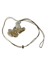 Necklace with floral design and beads on a white background