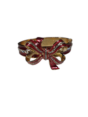 Red and gold bow-shaped bracelet on a white background