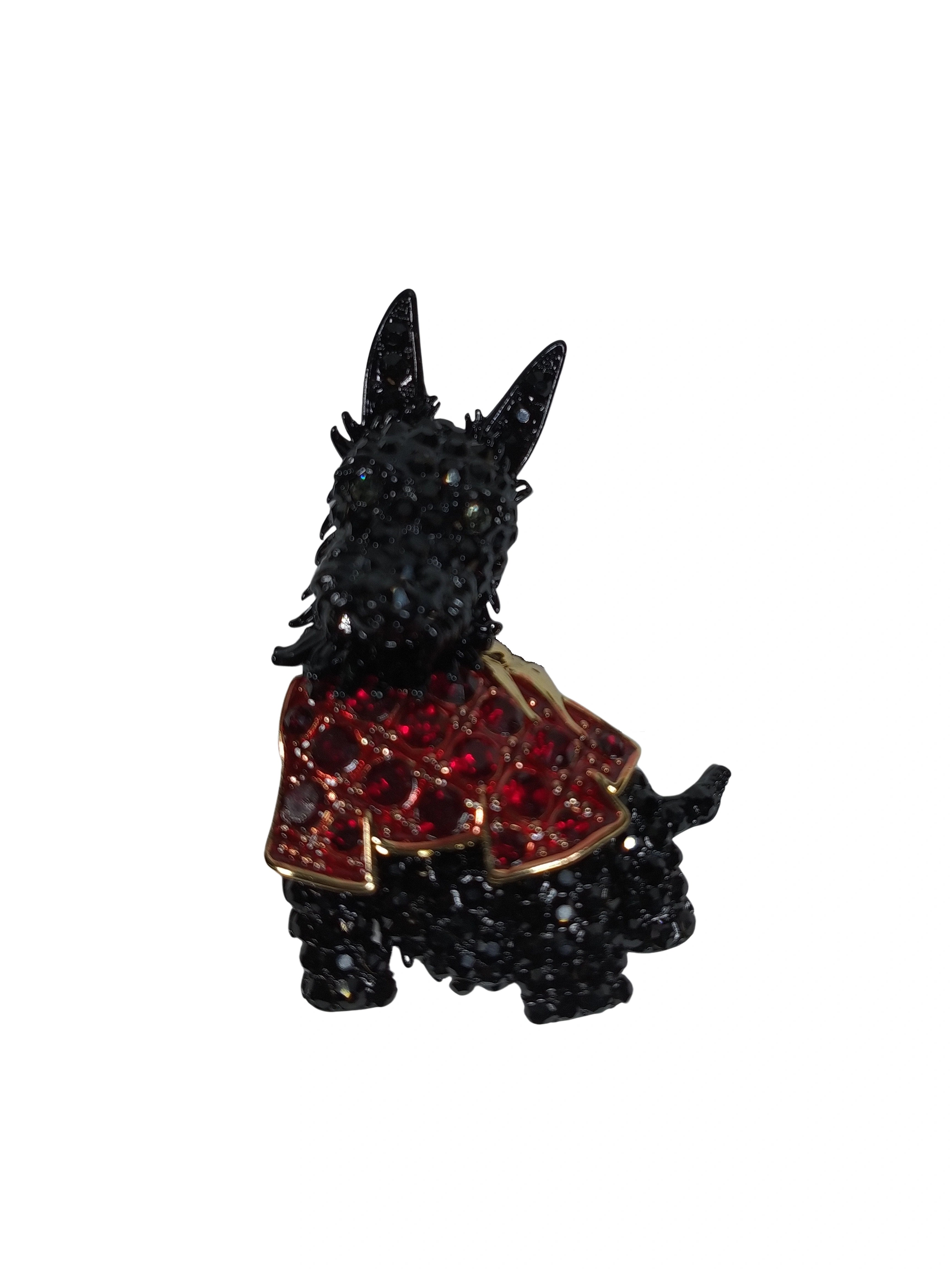 Black Scottie dog figurine with a red jacket on a white background
