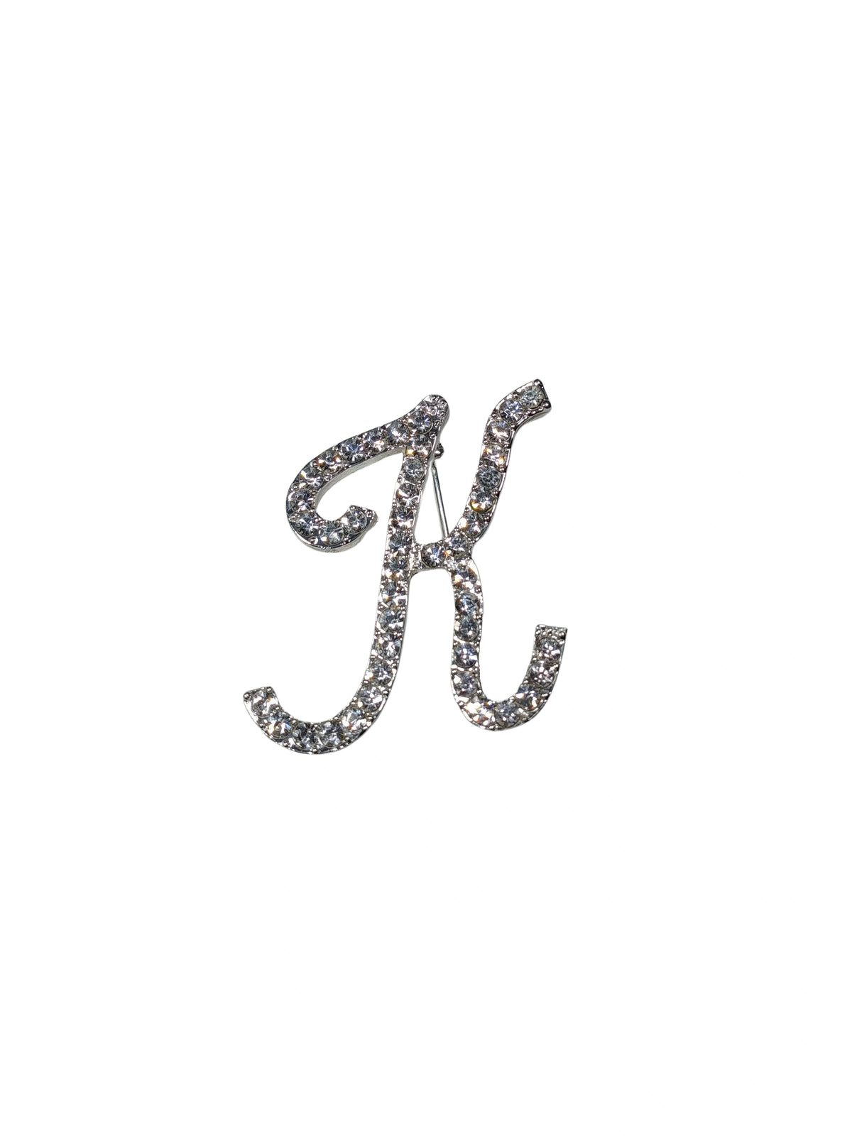 Silver brooch with letter 'K' design on a white background
